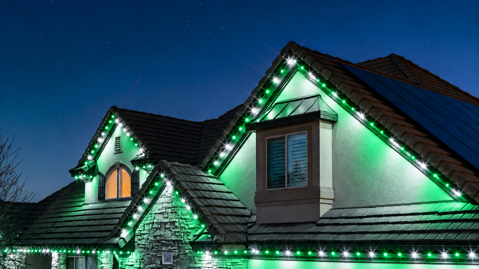 Trimlight permanent lights in green and white team colors for game day, shown on an example home