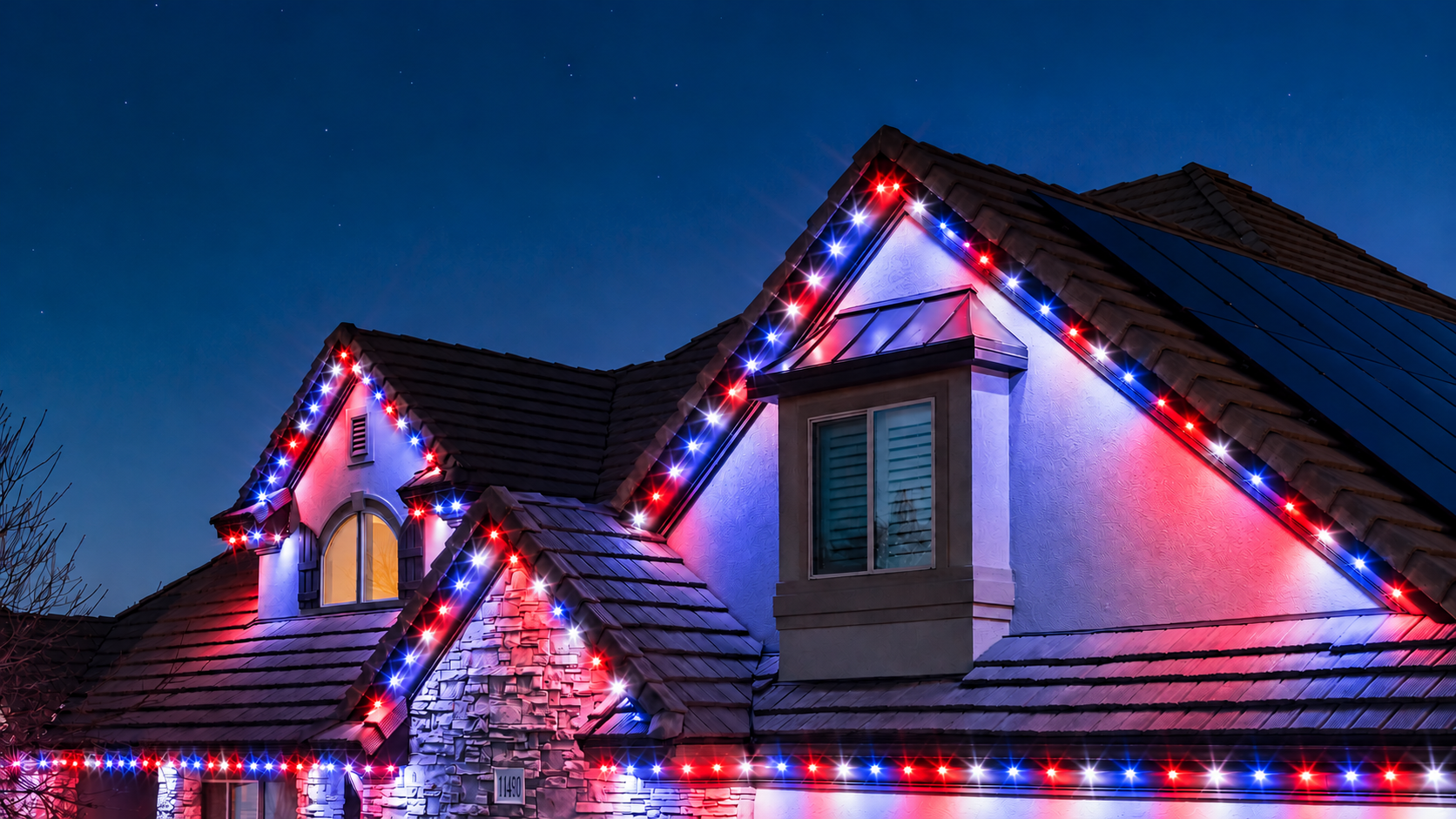 Trimlight permanent lights in red, white and blue for the Fourth of July, shown on an example home