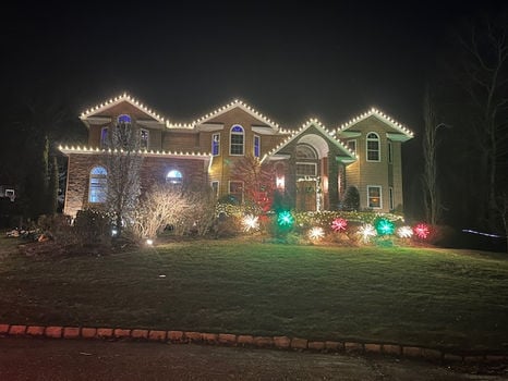 Warm white Christmas light installation on a North Shore home by Island Nights Outdoor Lights